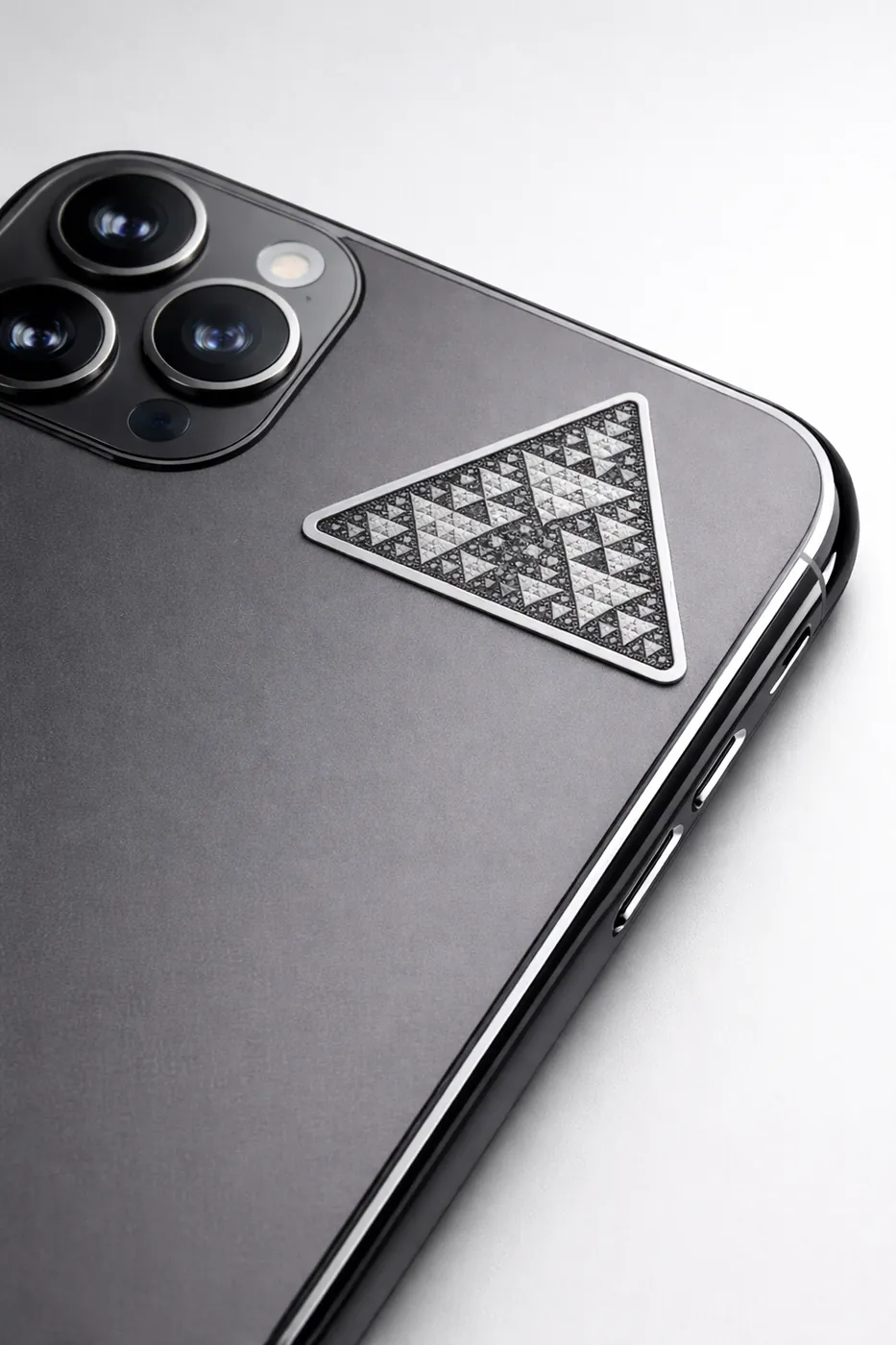 Black and white FractalGuard module placed on a phone case